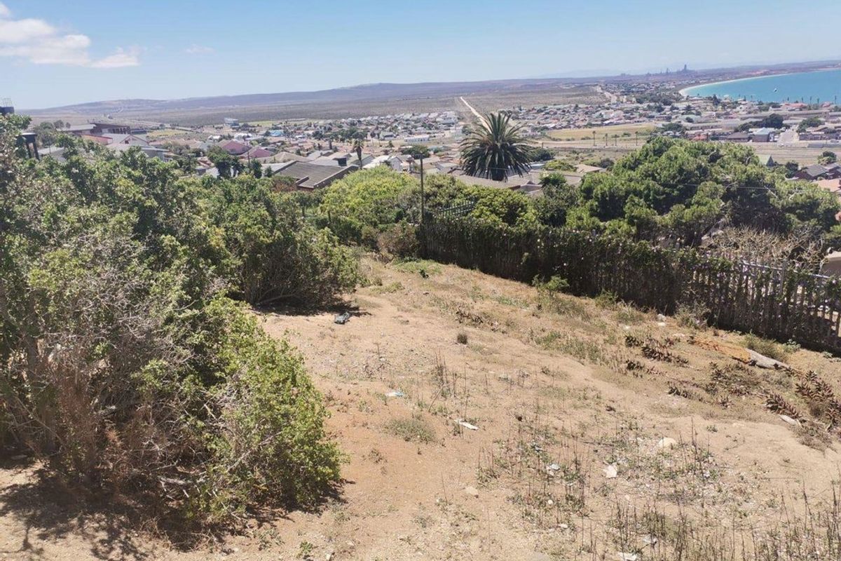 An elevated view overlooking the coastal residential area and surrounding landscape from the vacant land plot.