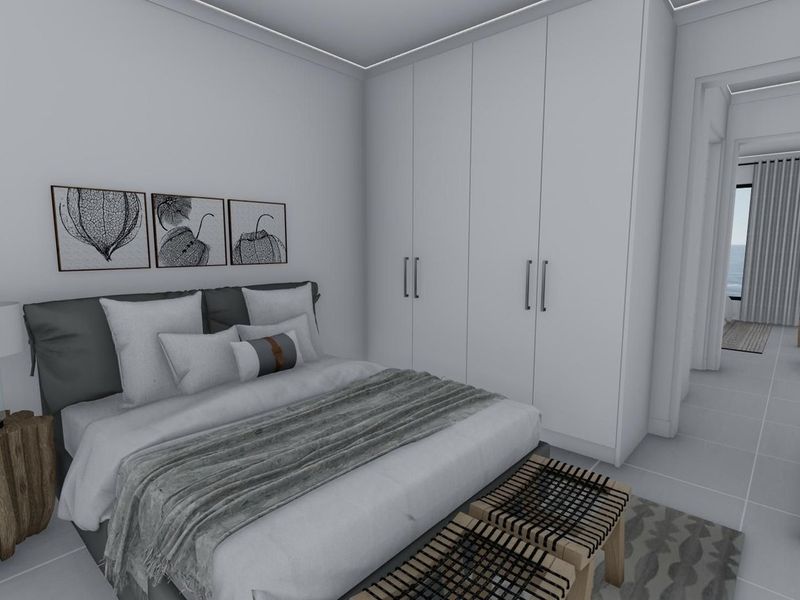 A modern bedroom featuring built-in floor-to-ceiling cupboards and recessed ceiling lighting, presented as a clean, contemporary interior space.