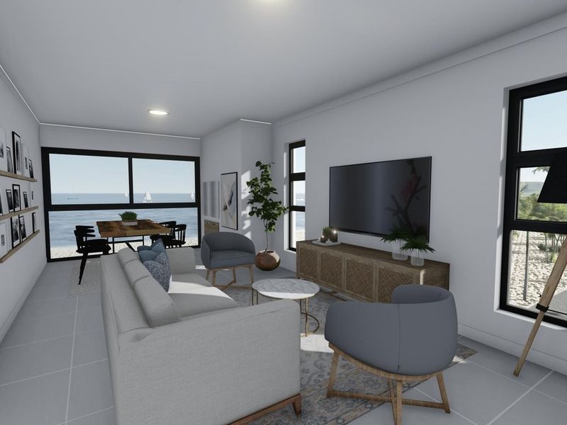 Bright open-plan living and dining area featuring large windows and sliding doors with expansive ocean views and modern tiled flooring.