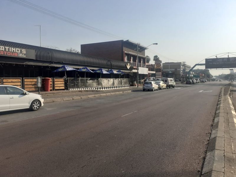 Street-level view of a commercial property featuring a pub and lounge with an outdoor seating area along the main road.