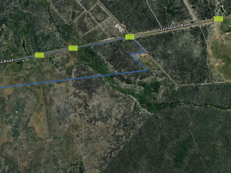 An aerial view showing the boundaries of the vacant residential land plot located along Yzerfontein Road.