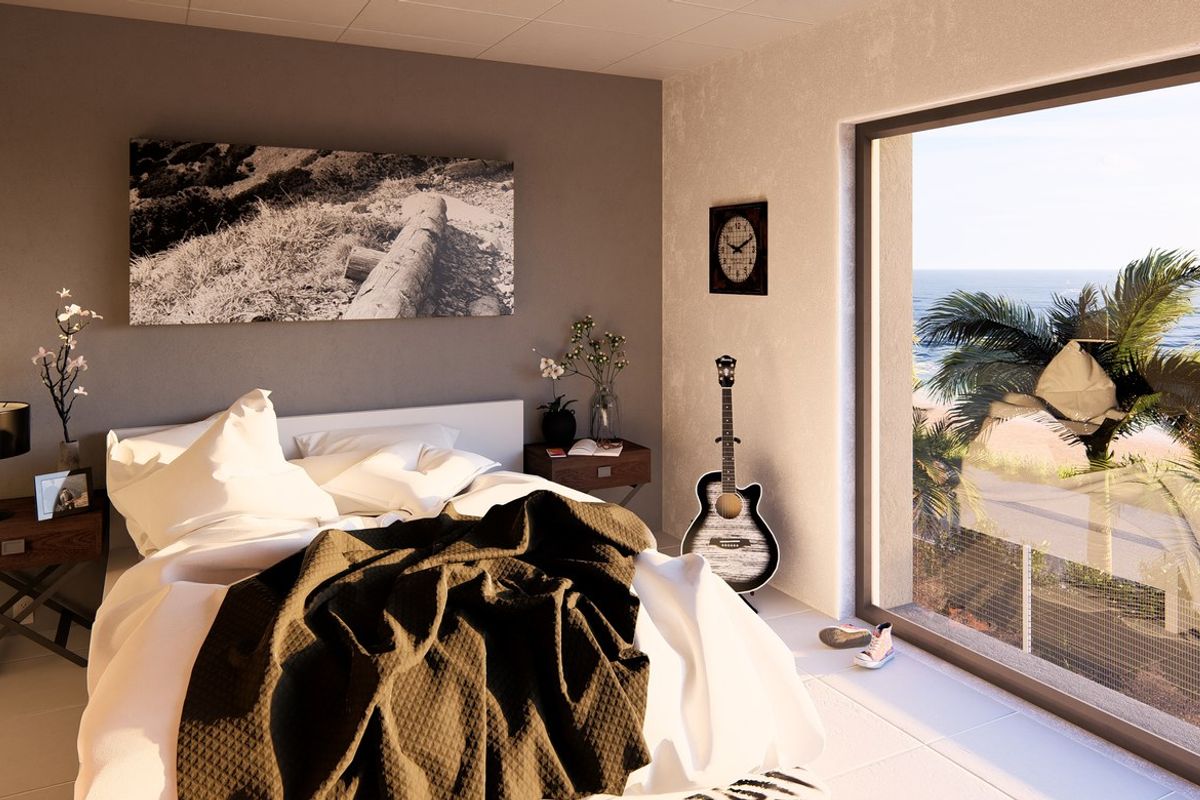 A modern bedroom featuring large sliding glass doors that provide natural light and a scenic view of the beach and palm trees.