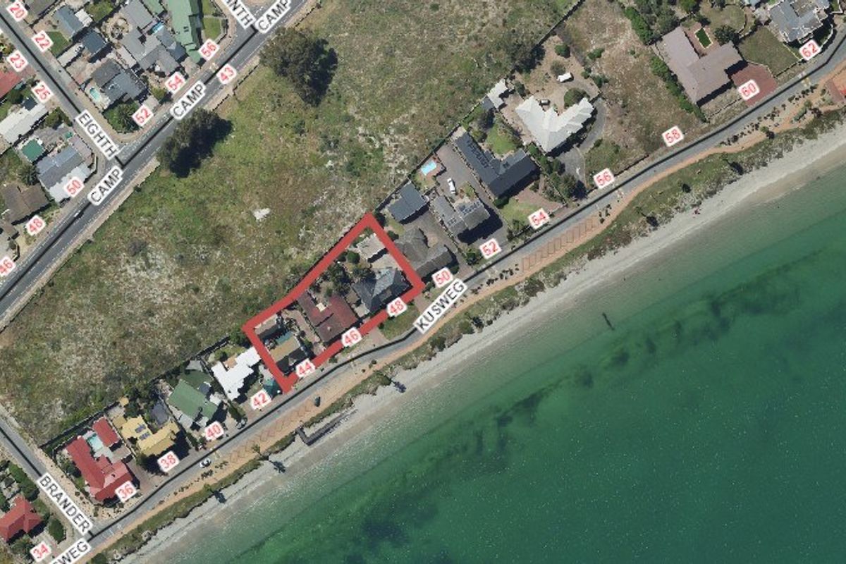 Aerial view of the property location highlighting the coastal position and proximity to the beach.