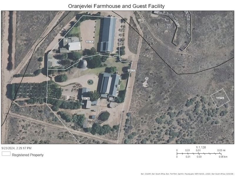 An aerial view of the Oranjevlei farmhouse and guest facility property, showing the layout of buildings, grounds, and surrounding landscape.