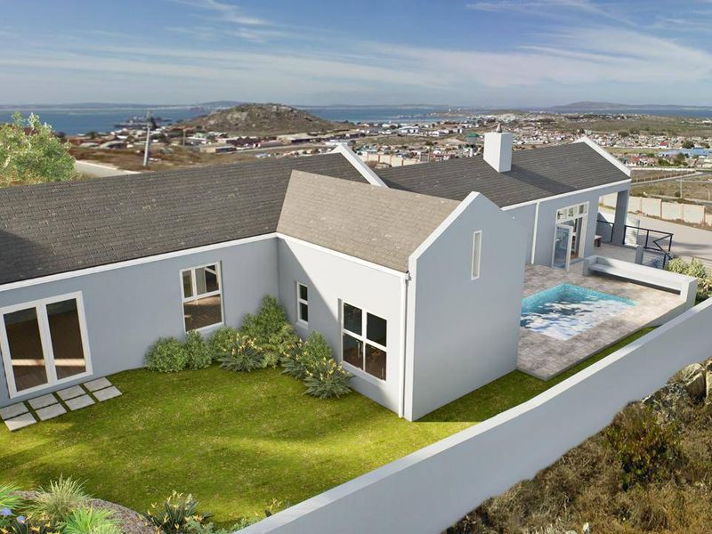 Aerial view of a residential property featuring a swimming pool, patio area, and landscaped garden with coastal views.