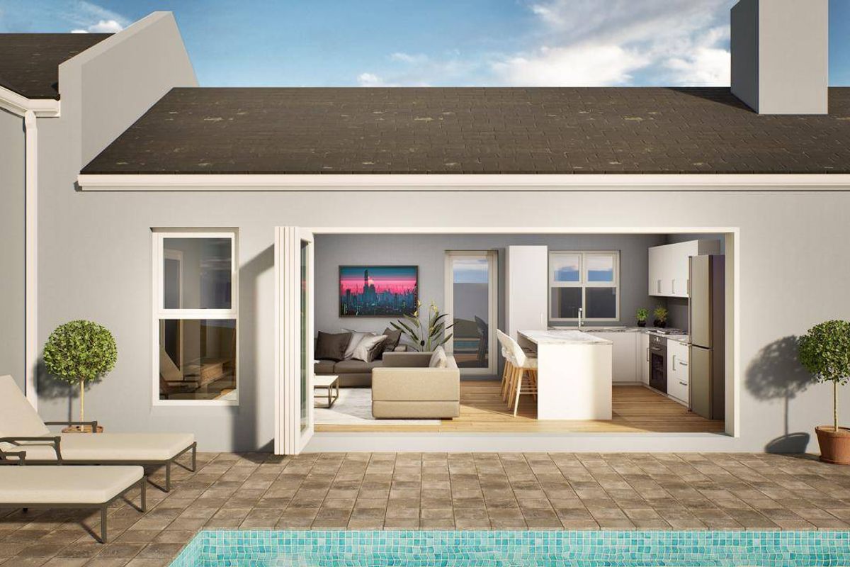 Rear view of the property featuring a tiled patio area, swimming pool, and seamless indoor-outdoor flow through large bi-fold doors.