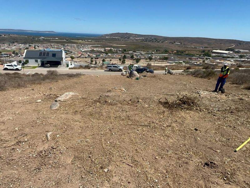 Elevated view overlooking the surrounding residential area and coastline from the vacant residential plot.