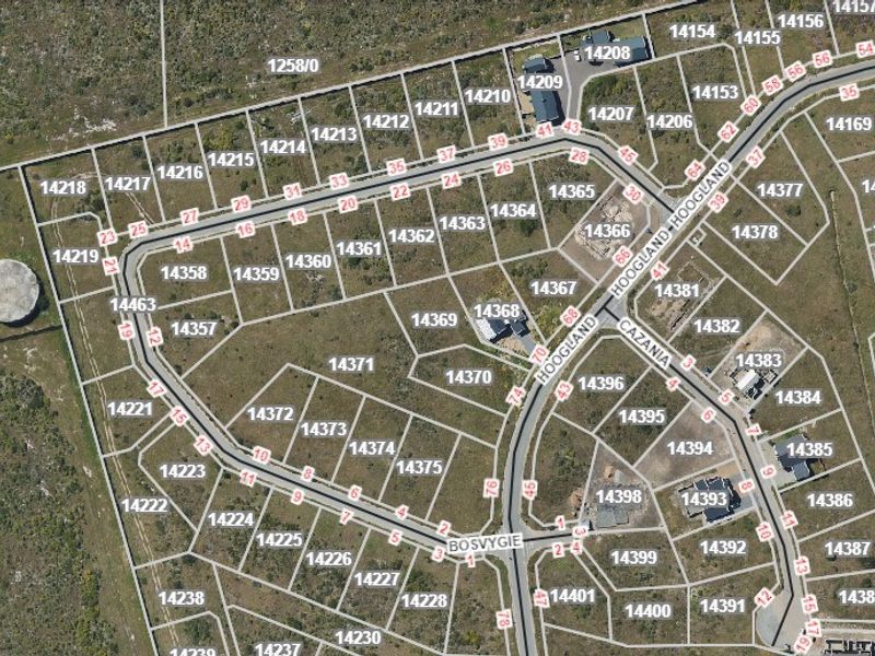 An aerial view showing the layout of residential vacant land plots and street infrastructure within the estate.