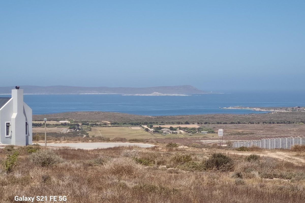 A scenic elevated view overlooking the coastal landscape and ocean, showcasing the natural surroundings of the vacant residential land.