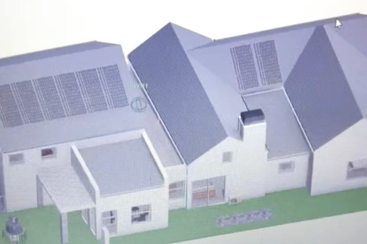 A 3D architectural rendering of a residential property featuring a pitched roof design, solar panels, and a chimney.