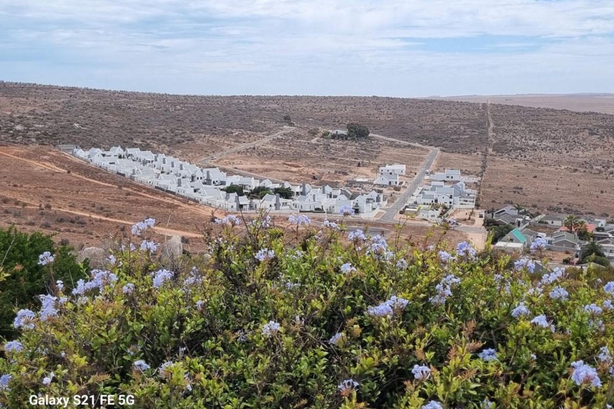 An elevated aerial view overlooking a residential development set within a natural, arid landscape.