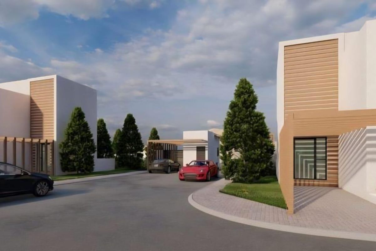 A modern residential street view featuring contemporary architectural design with timber accents, clean white facades, and paved driveway access.