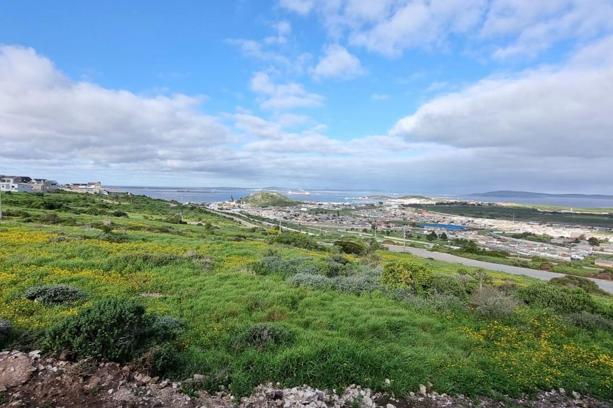 A view of the surrounding landscape and town from an unfinished room with exposed concrete block walls.