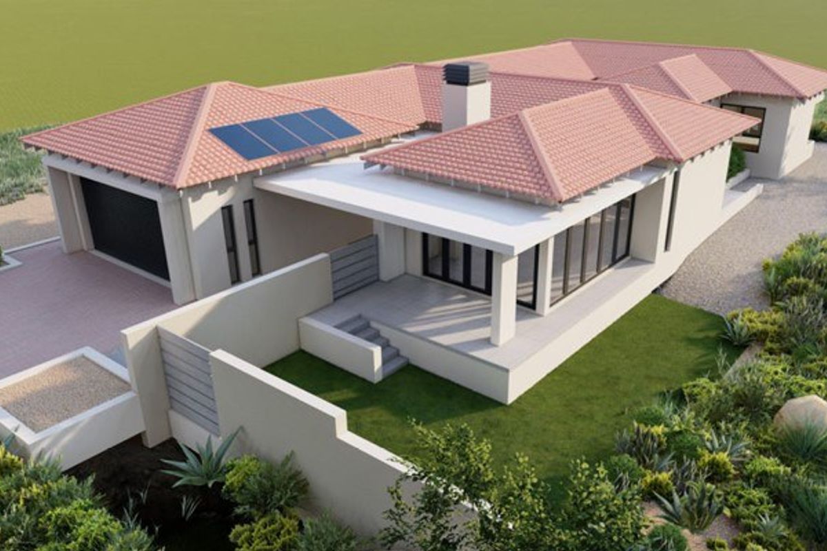 Aerial view of a modern single-story house featuring a tiled roof with solar panels, a covered patio, and a paved driveway.