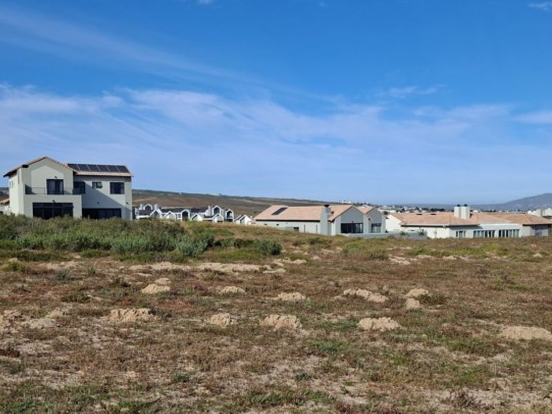 A view of a vacant residential plot situated within an established neighborhood, offering potential for new construction.