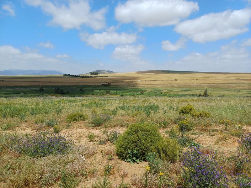 A wide-angle view of the expansive rural landscape and open fields surrounding the property.