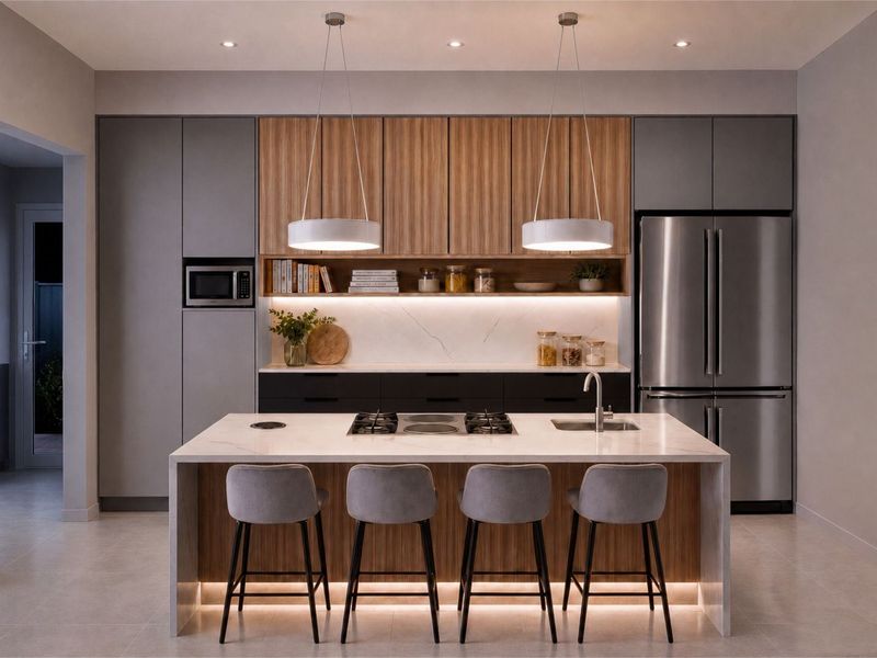Modern kitchen featuring a central island with stone countertops, integrated gas cooktop, undermount sink, and high-end cabinetry with warm wood and matte grey finishes.