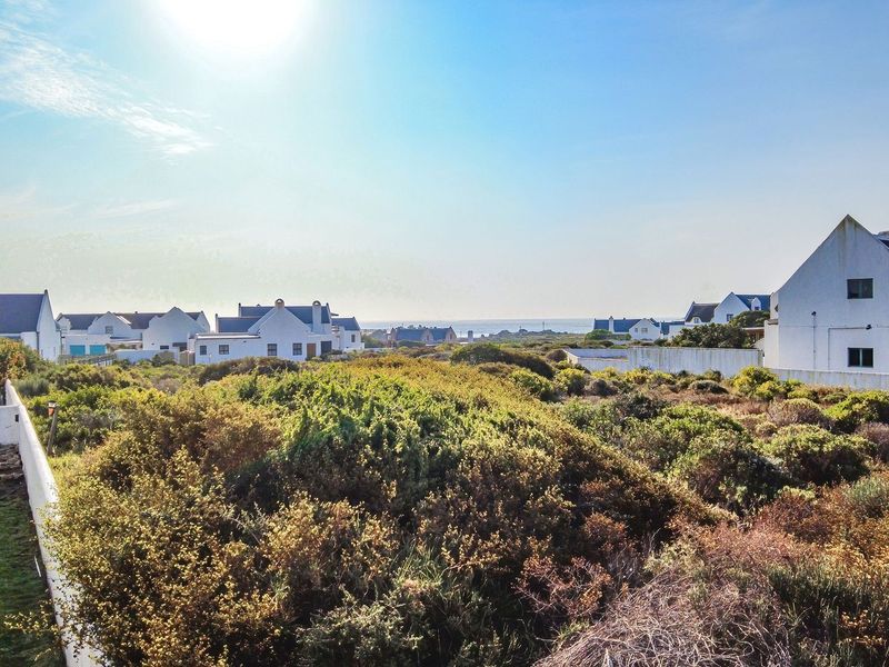 A scenic elevated view overlooking the coastal landscape and surrounding residential properties.
