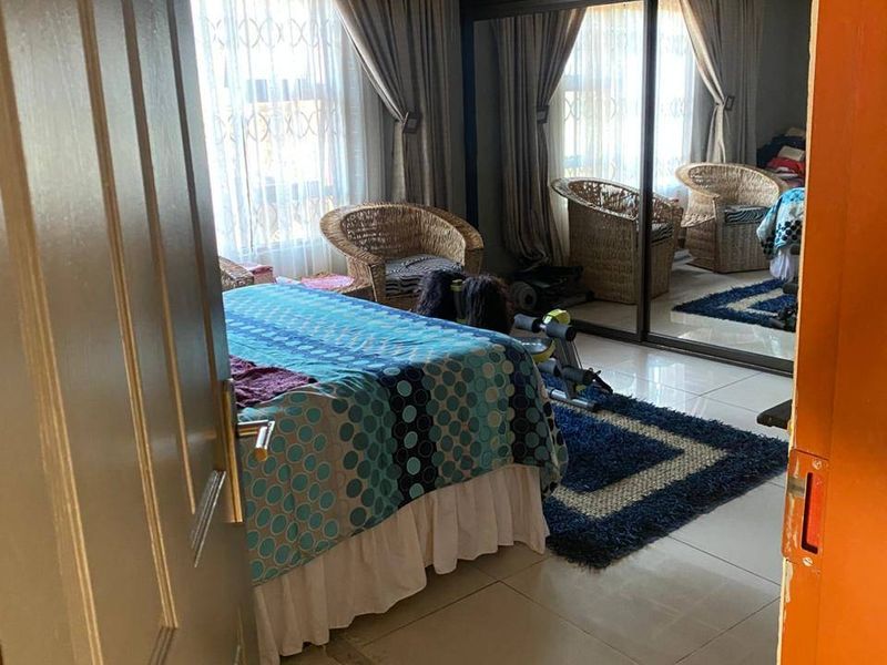 Bedroom featuring tiled flooring and a large built-in sliding door wardrobe, currently requiring ceiling completion and finishing works.