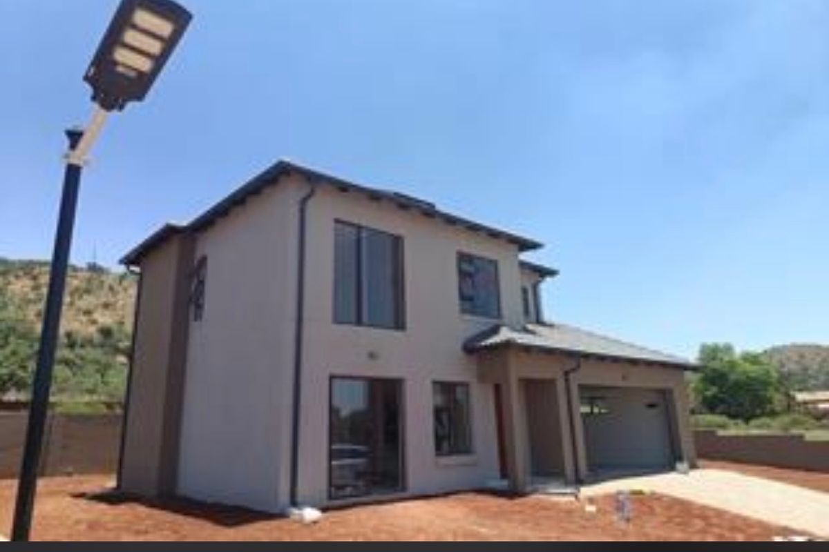 A modern double-storey residential property featuring a tiled roof, integrated garage, and paved driveway, set within an established estate environment.