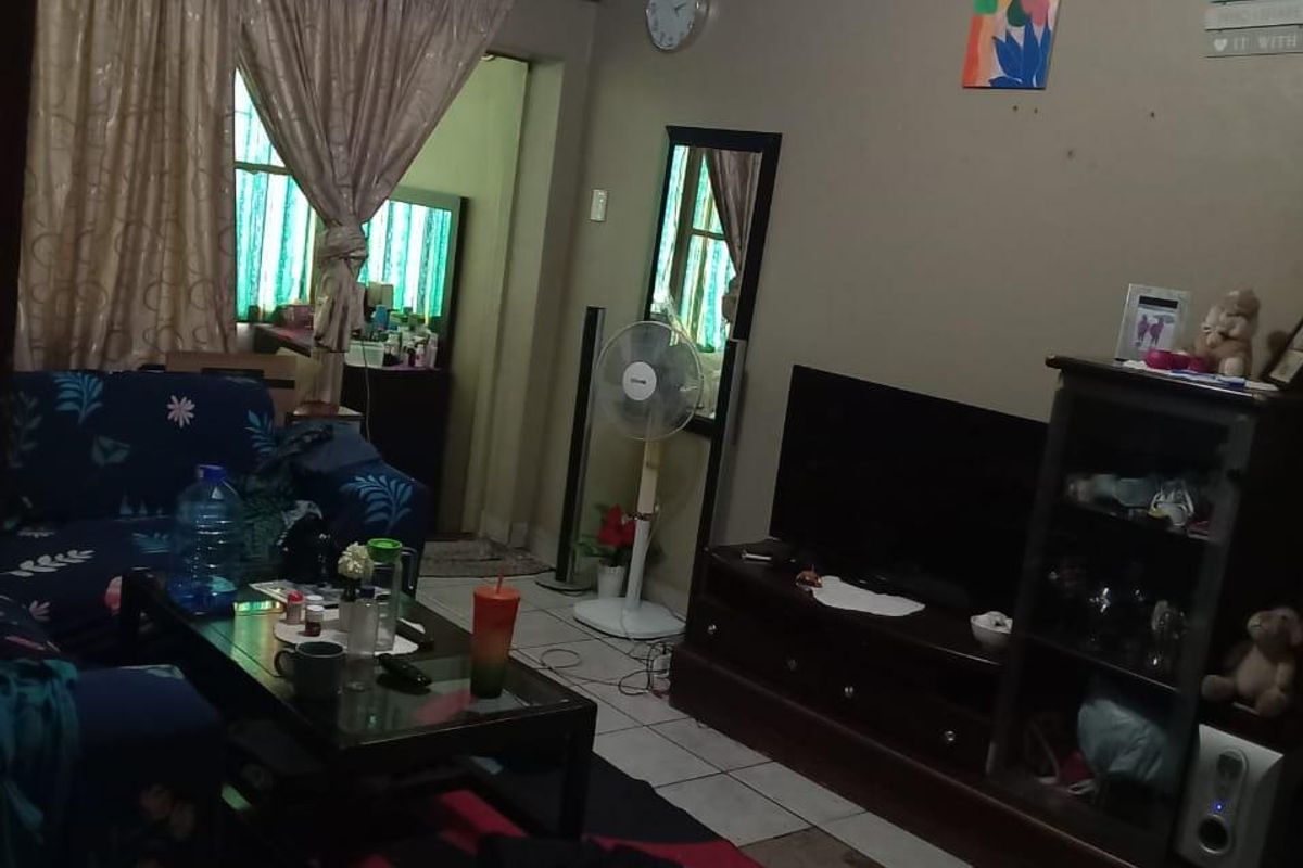 A living room area featuring tiled flooring and access to an adjacent room.