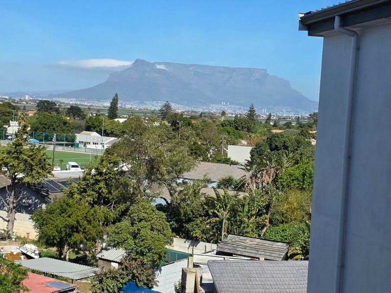 Elevated view overlooking the surrounding neighborhood with a prominent outlook towards Table Mountain.