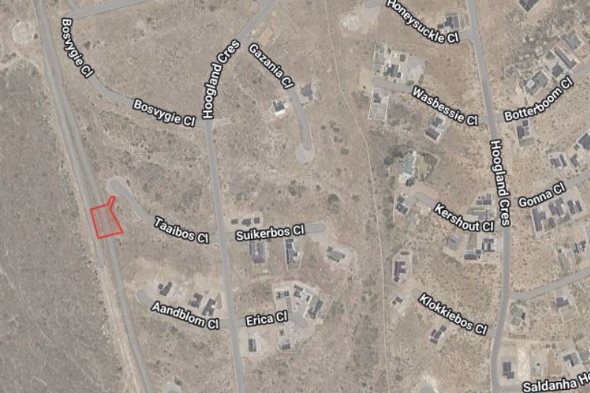 Aerial view of a residential vacant land plot highlighted in red, situated within a developed suburban street network.