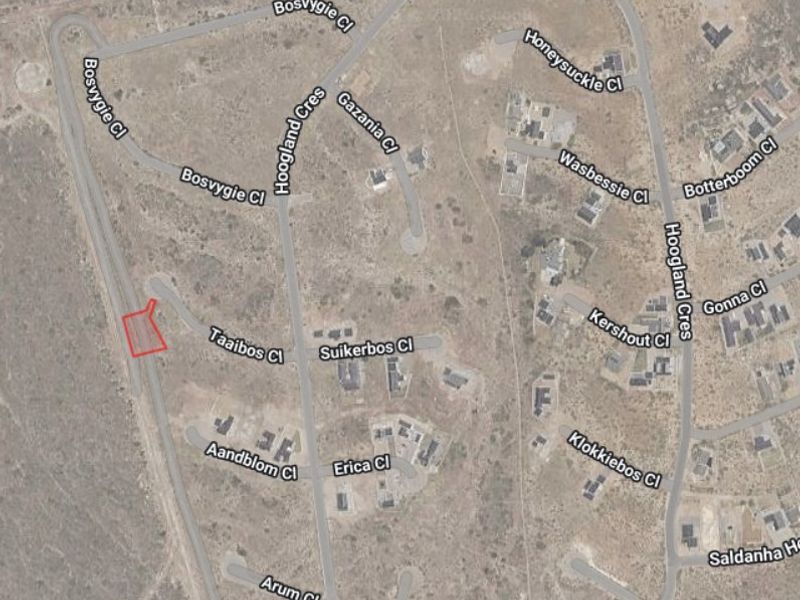 Aerial view of a residential vacant land plot highlighted in red, situated within a developed suburban street network.