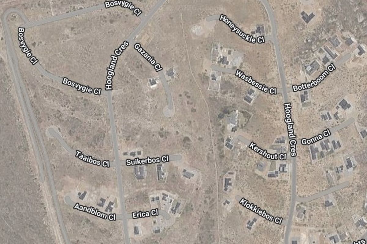 An aerial view of the residential estate showing the location of the vacant land plot highlighted in red.