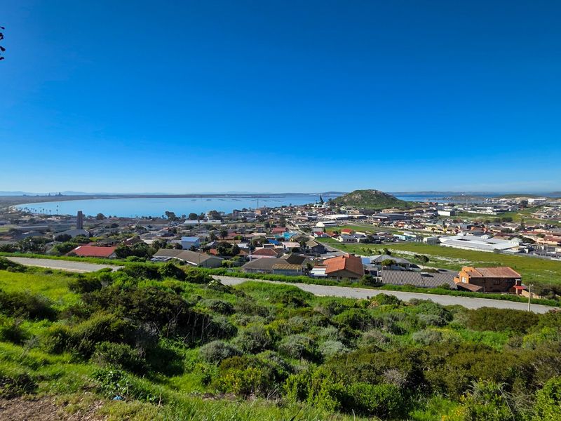 Panoramic elevated view overlooking the coastal town, surrounding landscape, and bay area.