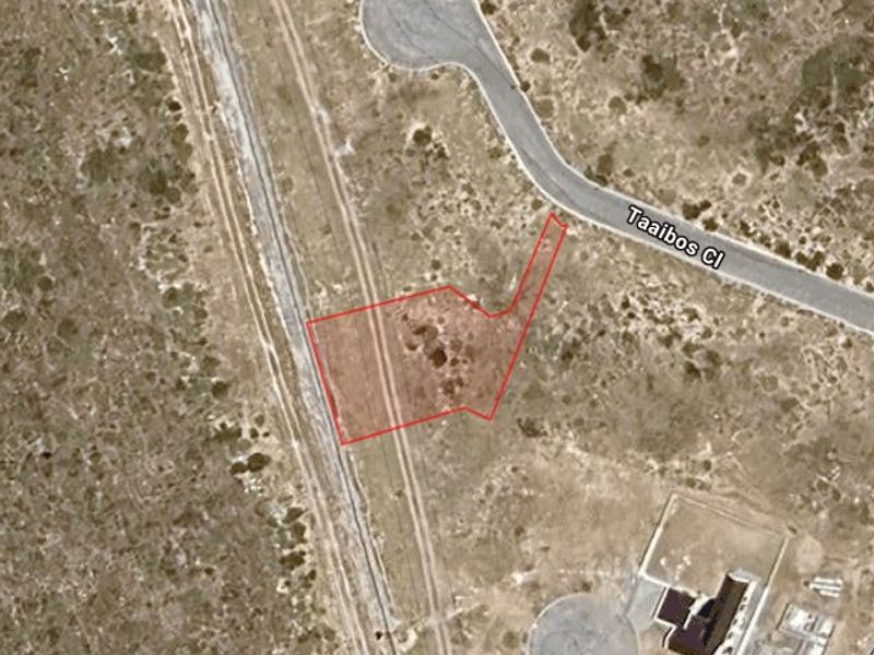 Aerial satellite view of a vacant residential plot outlined in red, situated near a cul-de-sac and adjacent to a railway line.