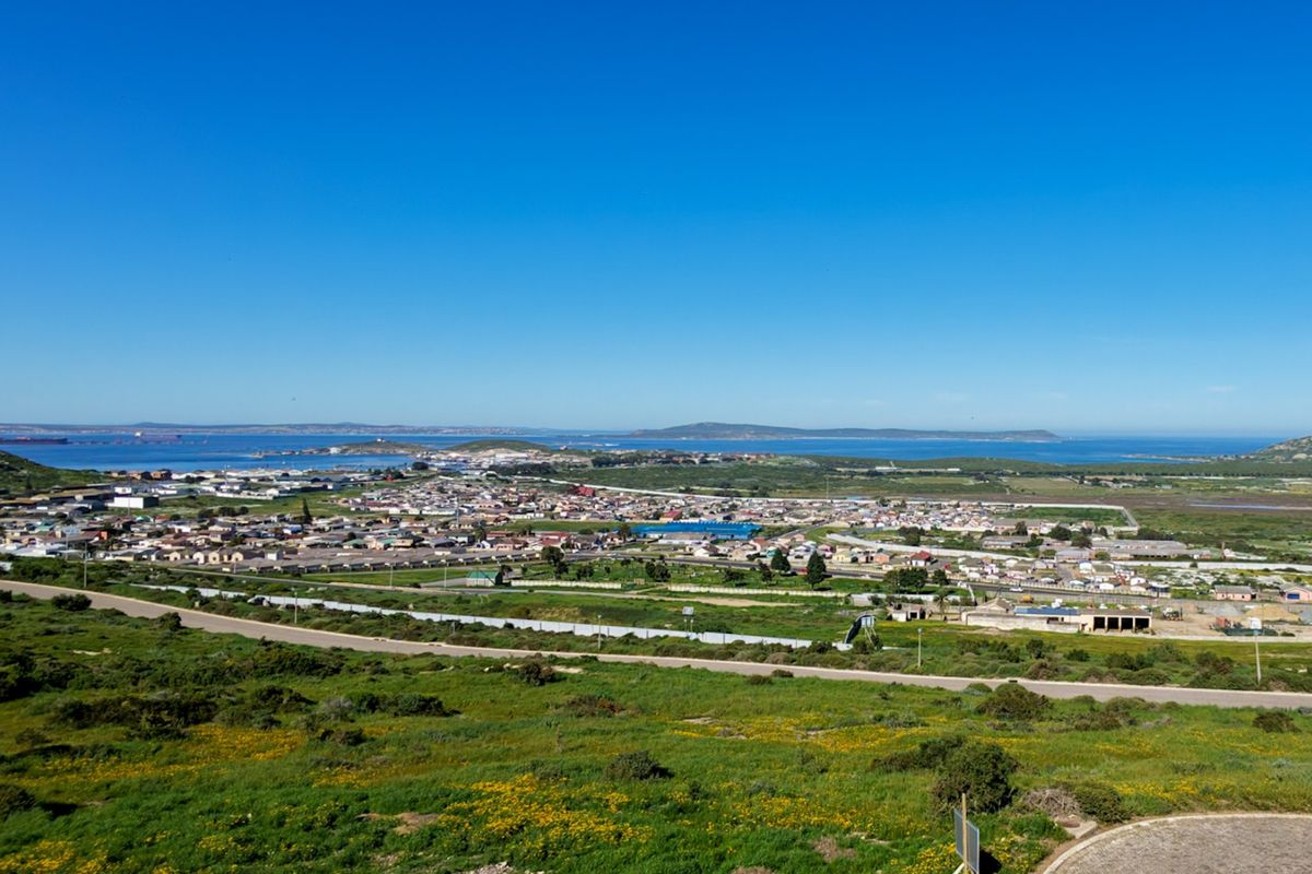 An elevated aerial view overlooking the surrounding residential landscape, coastal area, and distant horizon.