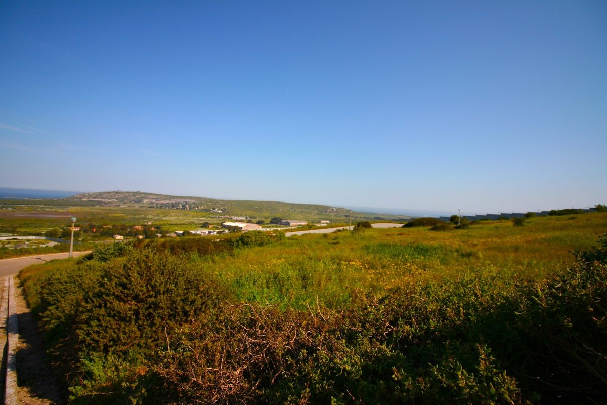 A wide-angle view of the surrounding landscape and natural terrain, showcasing the open space and distant horizon.