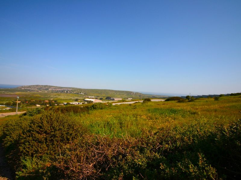 A wide-angle view of the surrounding landscape and natural terrain, showcasing the open space and distant horizon.