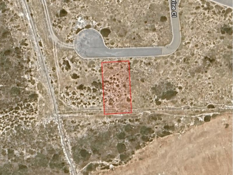 Aerial view of a vacant residential plot situated in a quiet cul-de-sac, offering a prime opportunity for new construction.