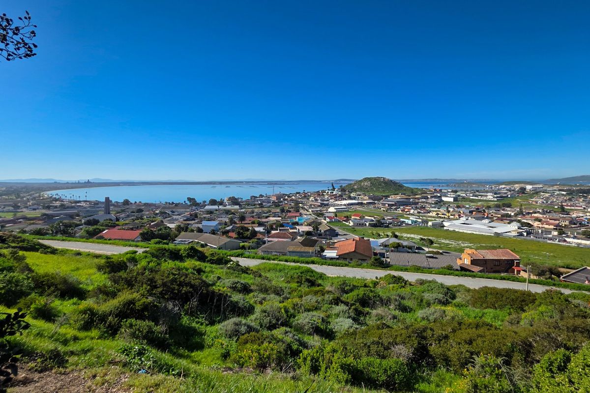 Panoramic elevated view overlooking the coastal town, surrounding landscape, and bay area.