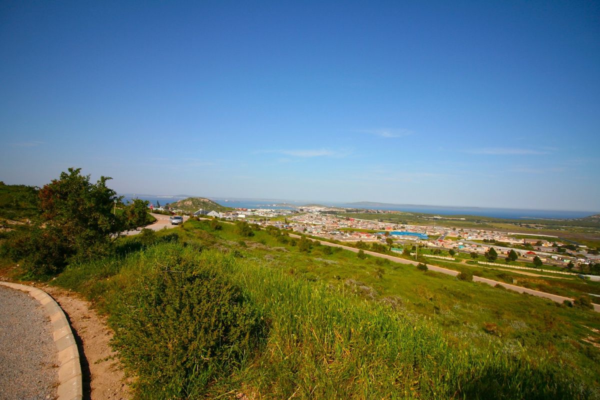 A scenic elevated view overlooking the surrounding landscape, residential area, and distant coastline.