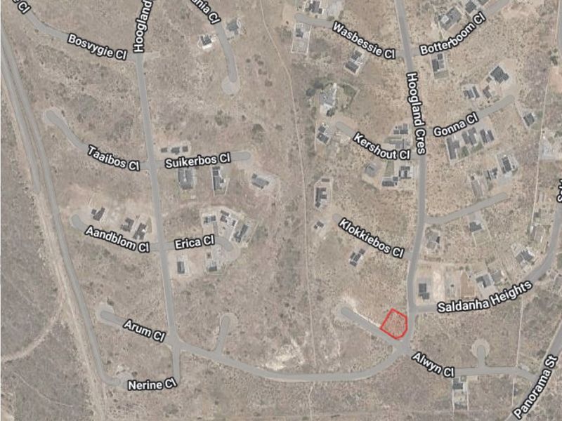 Aerial view of a vacant residential land plot highlighted in red, situated within a developed suburban street network.