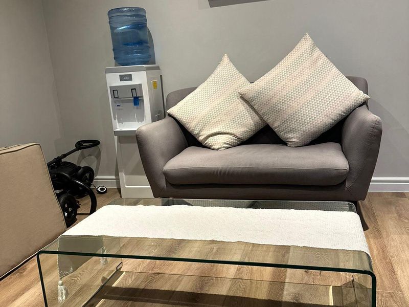 A cozy living area featuring modern laminate flooring and neutral wall finishes, providing a clean and functional space.