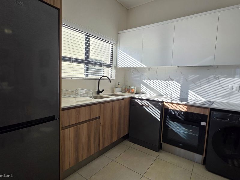 Modern kitchen featuring sleek wood-grain and white cabinetry, marble-look splashback, integrated appliances, and high-quality finishes throughout.