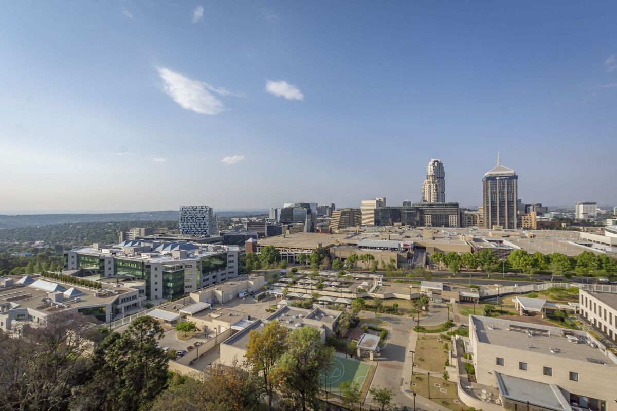 Elevated aerial view showcasing the surrounding urban landscape and city skyline.