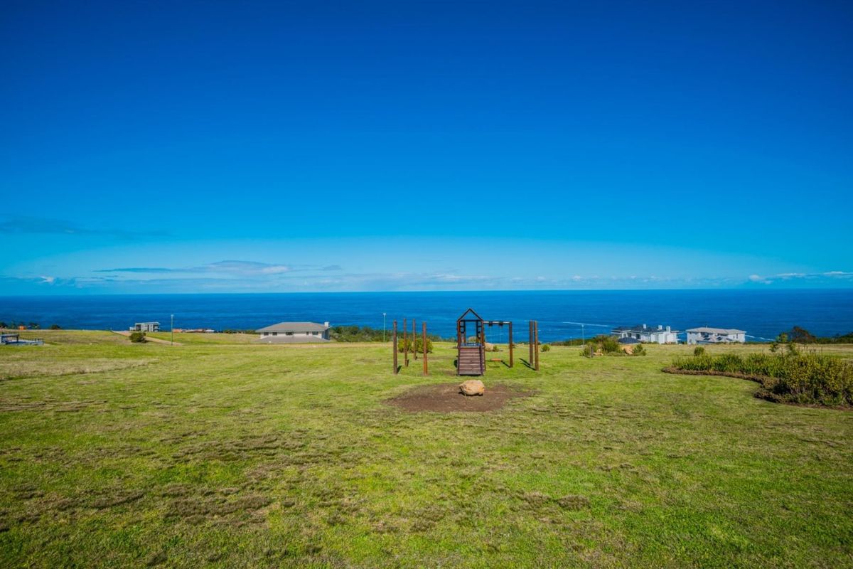 Expansive vacant residential land featuring a clear, elevated ocean view and well-maintained grassy terrain.