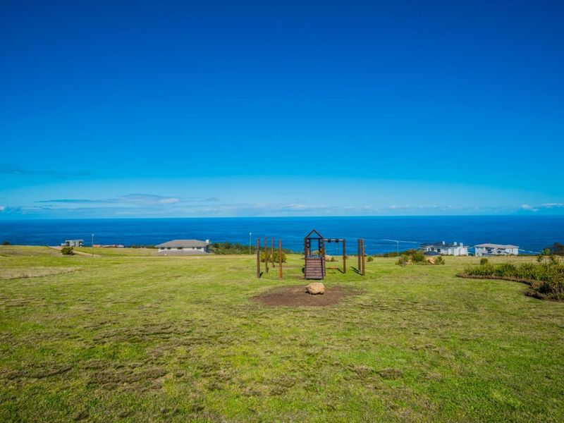 Expansive vacant residential land featuring a clear, elevated ocean view and well-maintained grassy terrain.