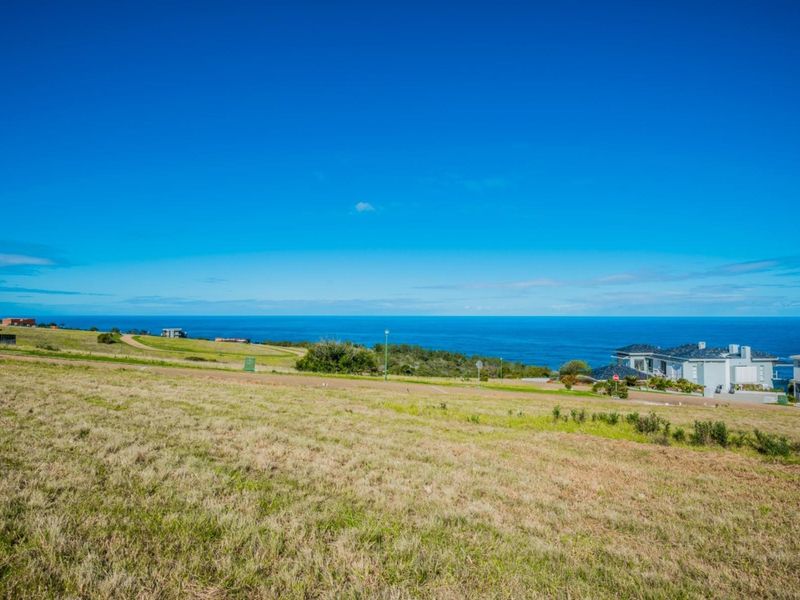 A wide-angle view of the vacant residential land overlooking the ocean and surrounding coastal landscape.