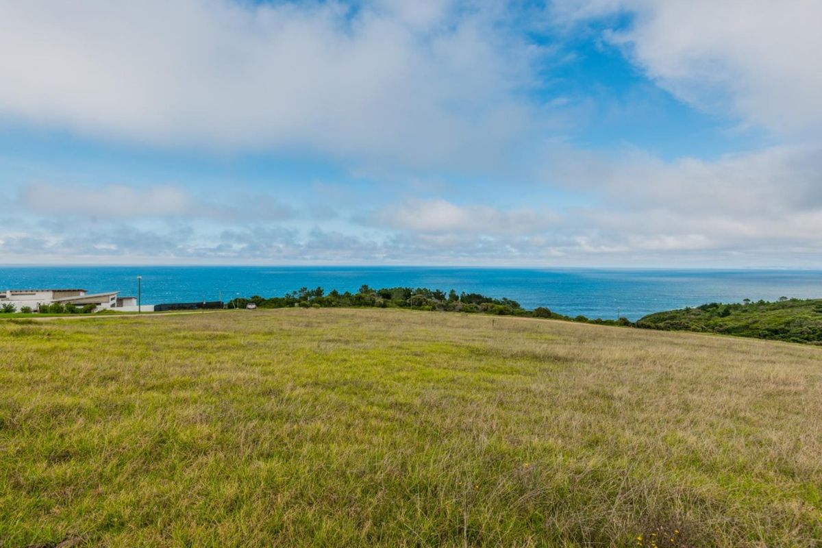 A scenic view of the ocean and coastal landscape from the vacant residential land.