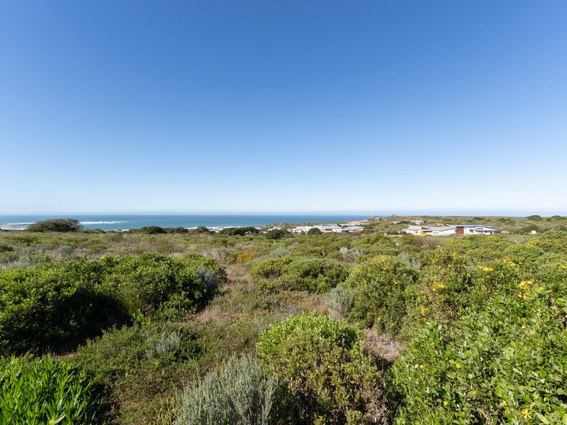 A scenic view of the coastal landscape and surrounding residential area from the vacant residential land.