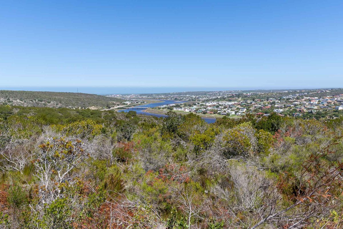 A scenic elevated view overlooking the surrounding landscape, river, and coastal town, showcasing the natural terrain of the vacant residential land.