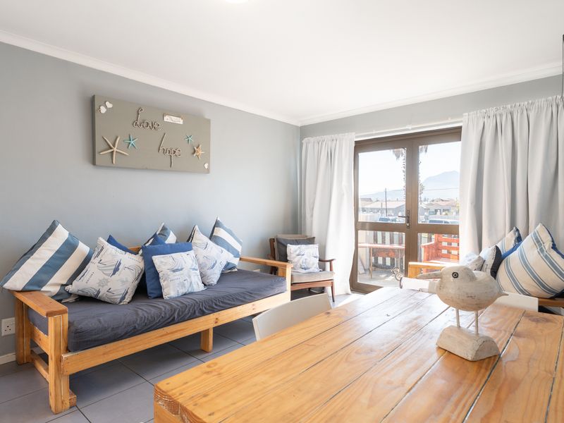 Open-plan living area featuring tiled flooring and a sliding glass door providing access to the outdoor space.