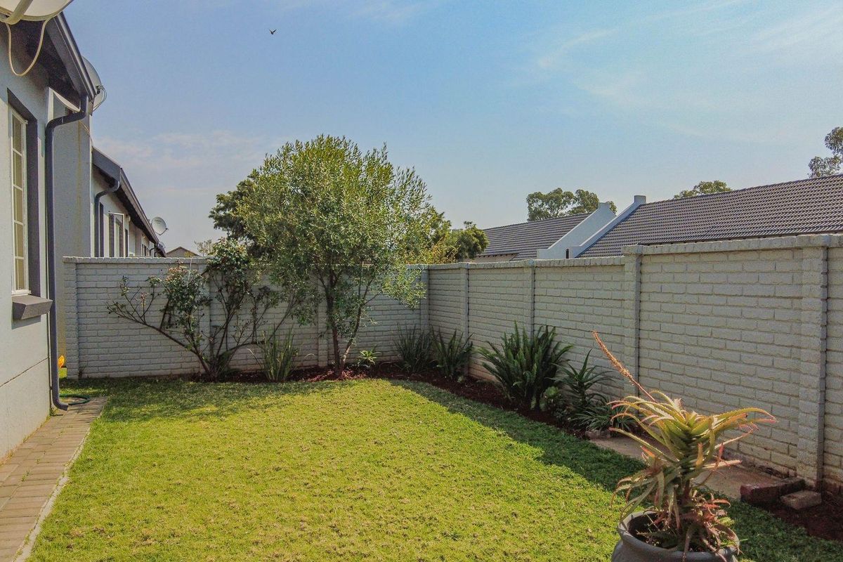 A private rear garden featuring a well-maintained lawn and perimeter brick walling, providing a secure and tidy outdoor space.