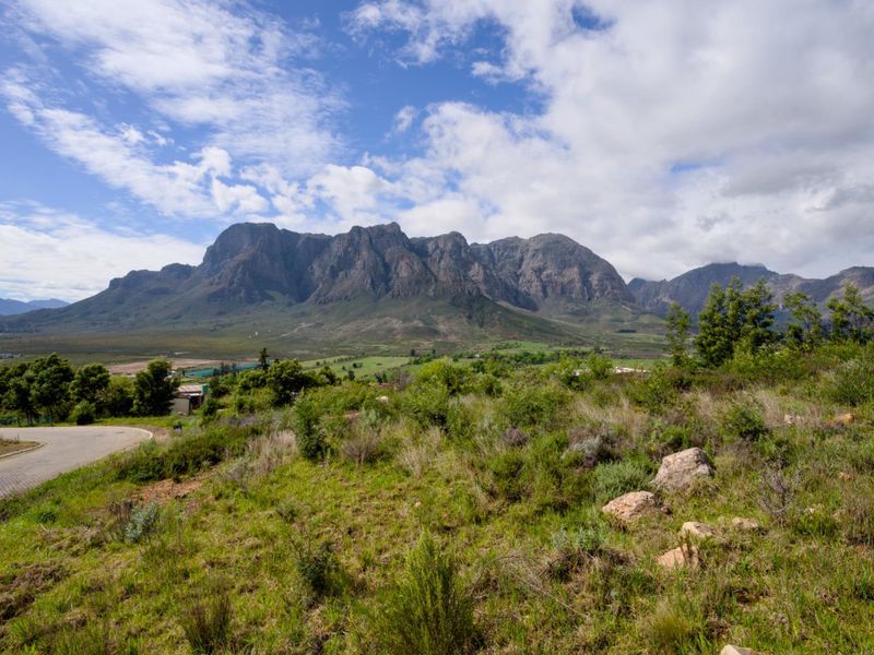 A scenic view of the surrounding mountain range and natural landscape from the vacant residential property.